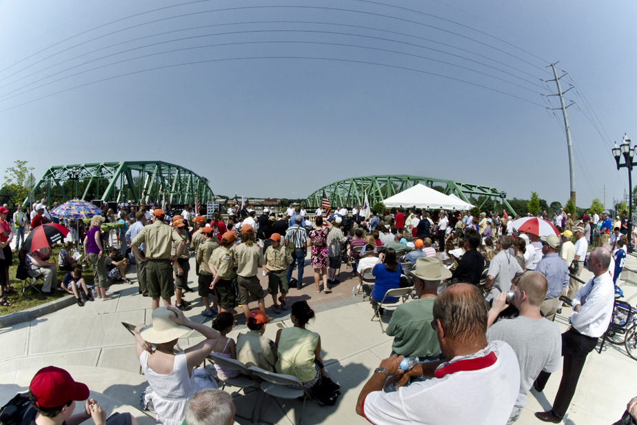 People watching speeches in front of bridges.